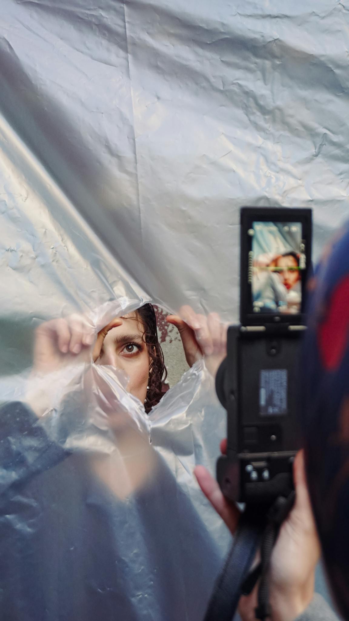 Artistic photo capturing a unique street portrait through a transparent sheet in Istanbul, Türkiye.